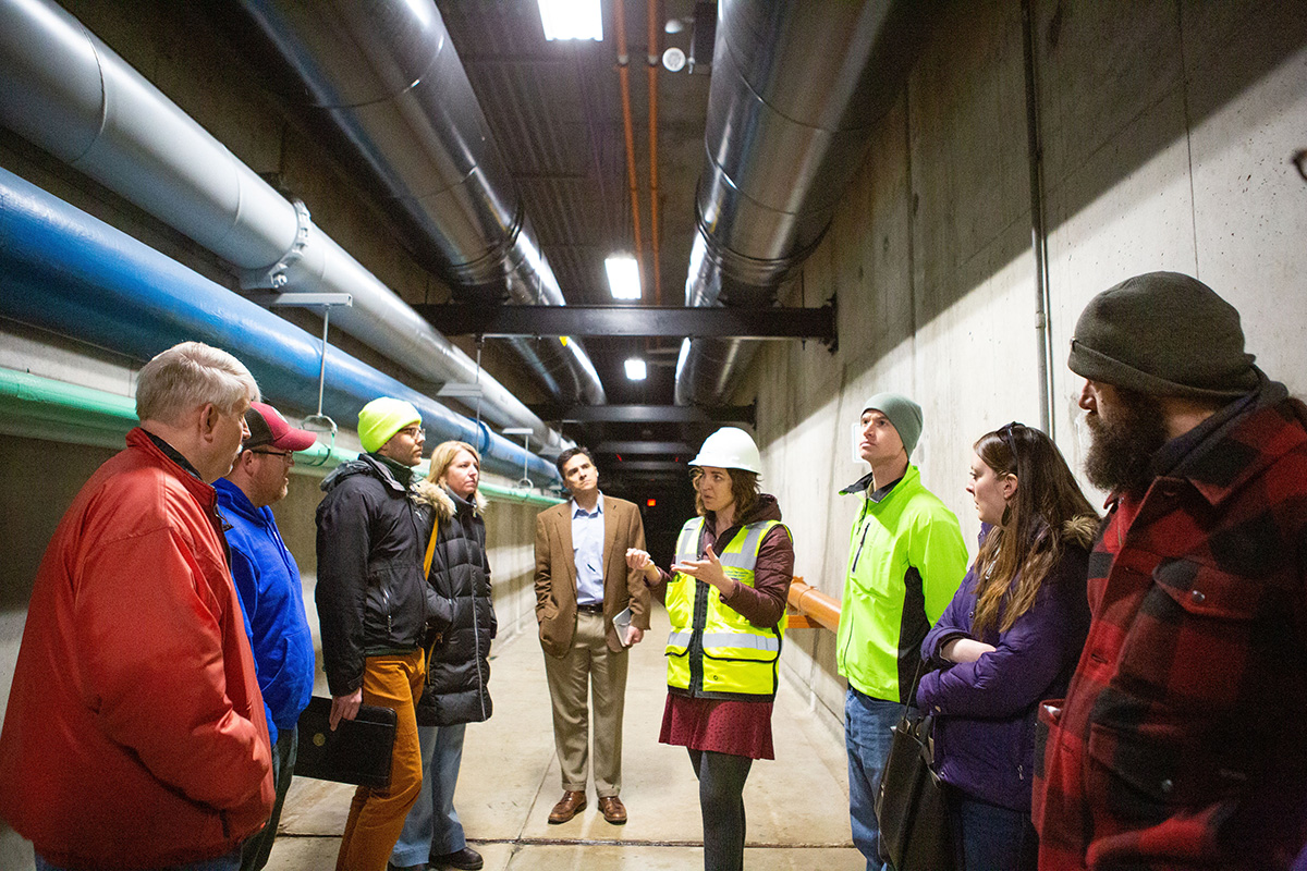 A District staff member showing a tour group underground tunnels.